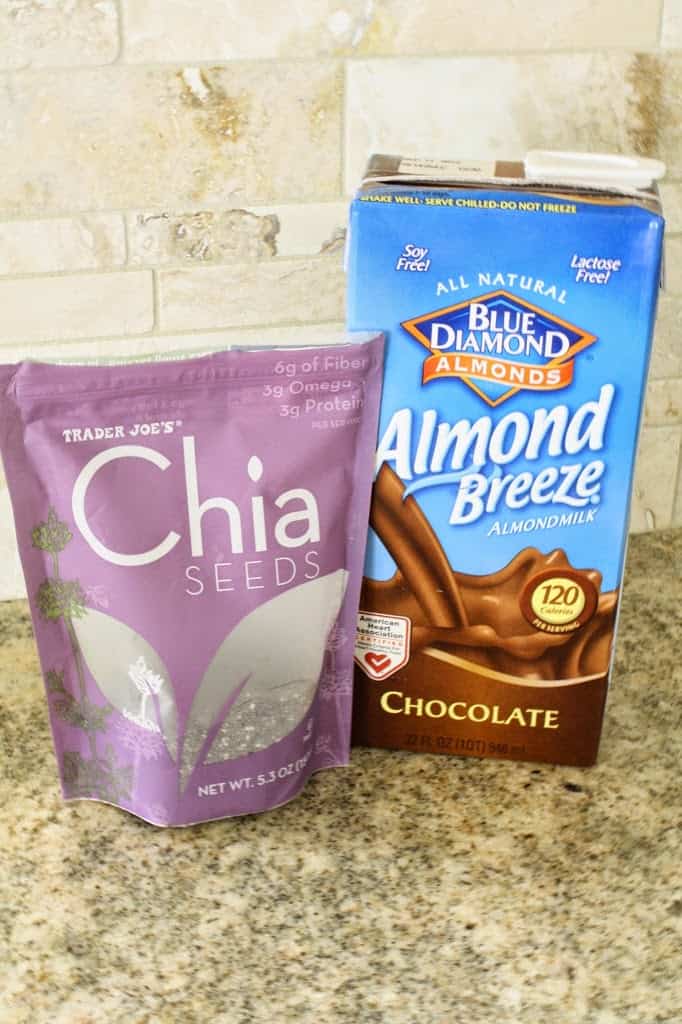 chocolate chia seed pudding ingredients on a counter: chia seeds in a purple bag and a carton of Blue Diamond Almond Breeze chocolate milk