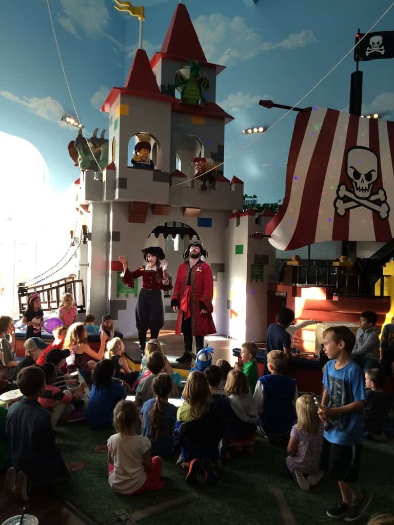 2 pirates on stage in front of crowd of kids at Legoland hotel