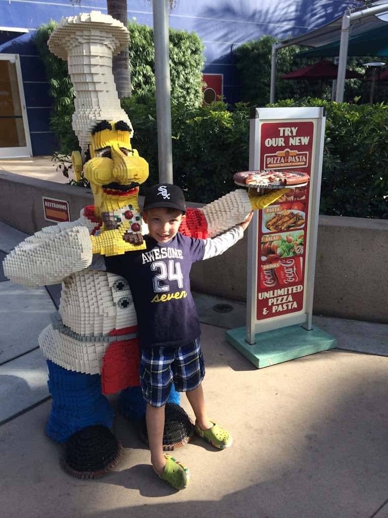 CJ posing with Lego chef statue