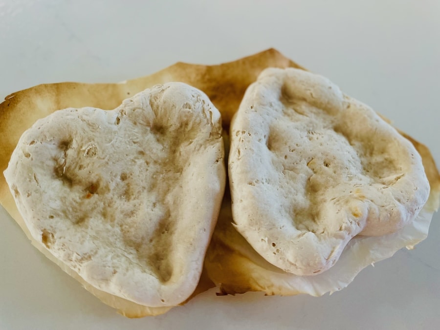 Birds Eye view: Two heart-shaped pizza crusts, par-baked.