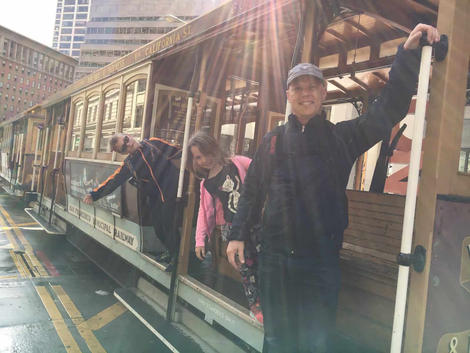 Dave, CJ & Miss E hanging off the side of a trolley car