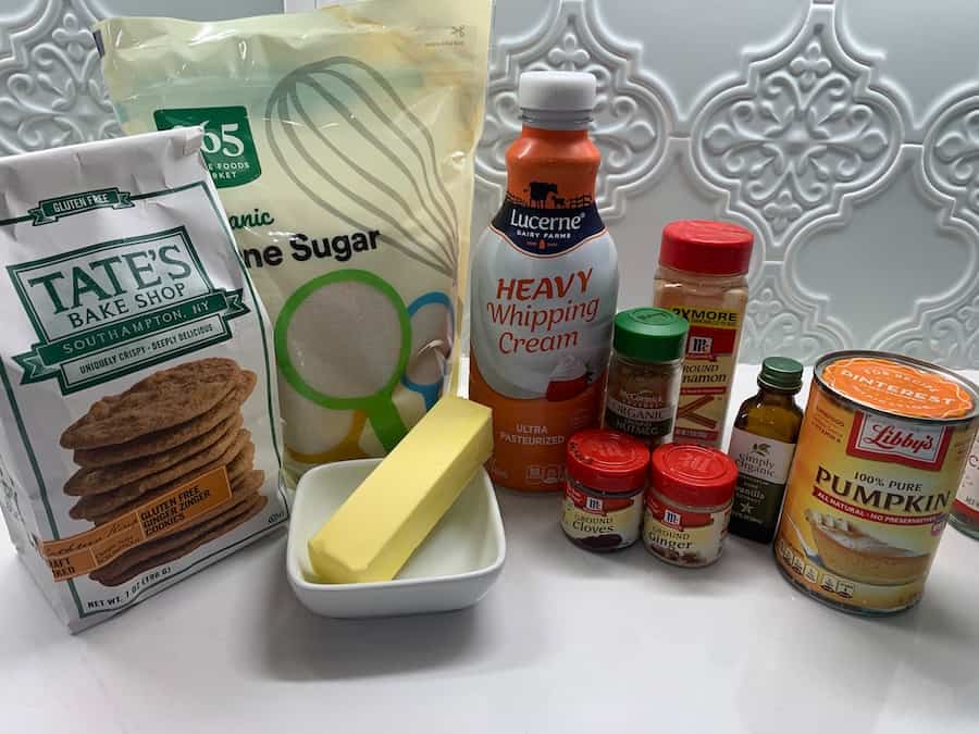 Ingredients for gluten-free pumpkin cheesecake bars: cookies, sugar, whipping cream, butter, pumpkin pie spices, vanilla and canned pumpkin