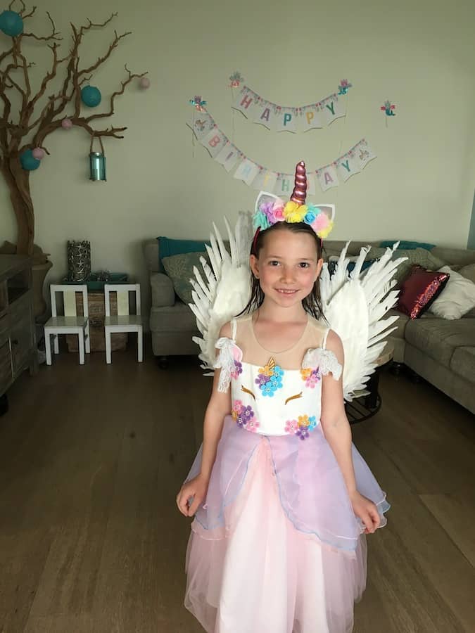 Miss E in a unicorn dress with pegasus wings