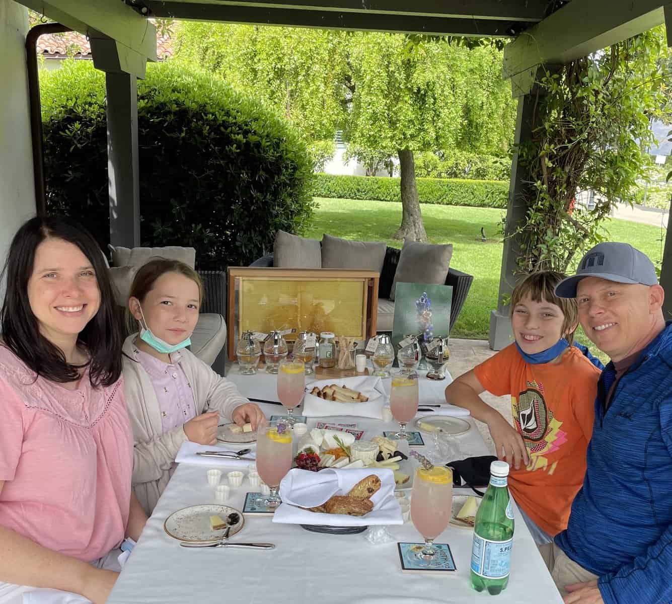 Heather and family at an outdoor table for gluten-free honey tasting