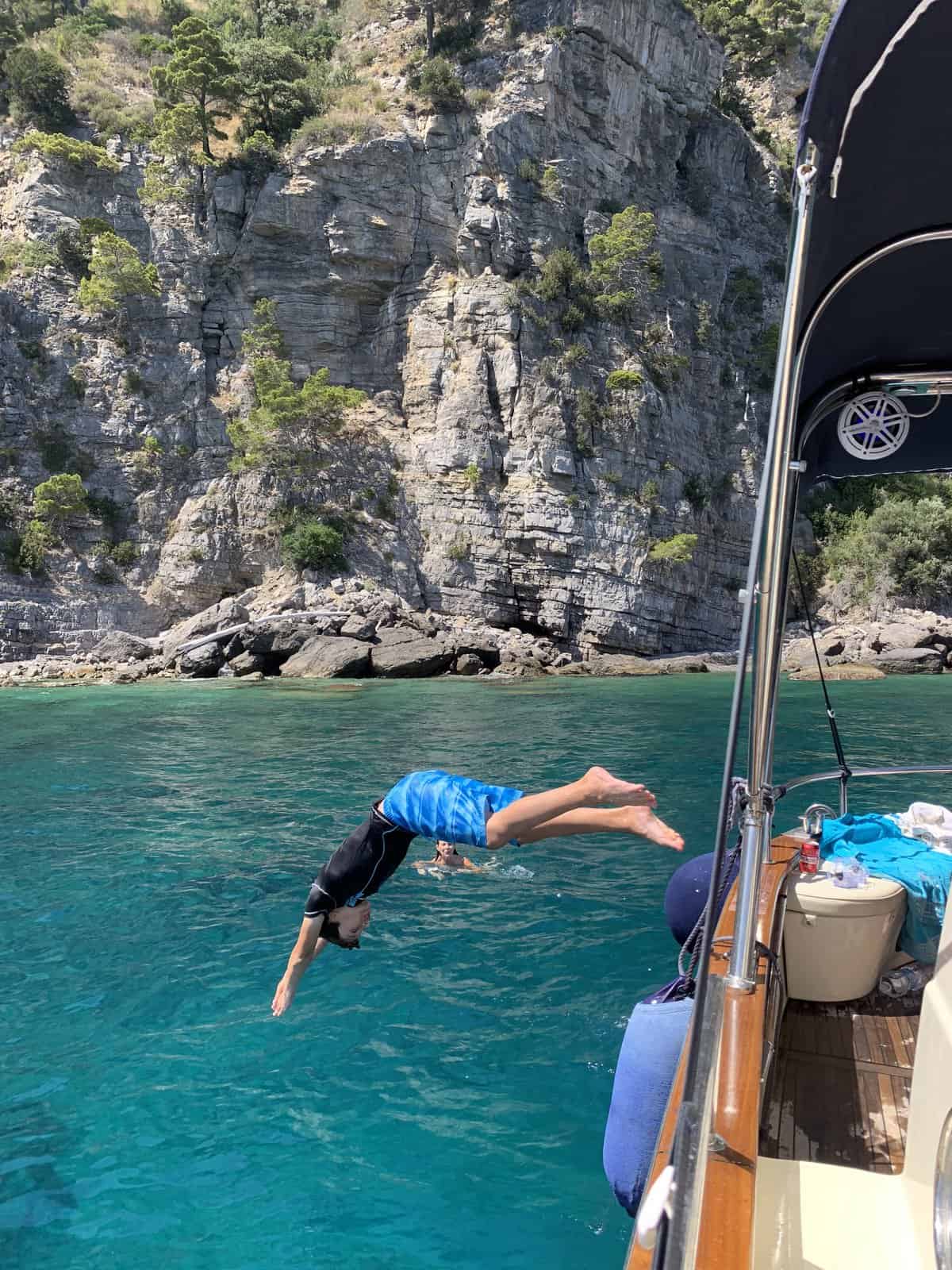 CJ diving off the boat into the Sea