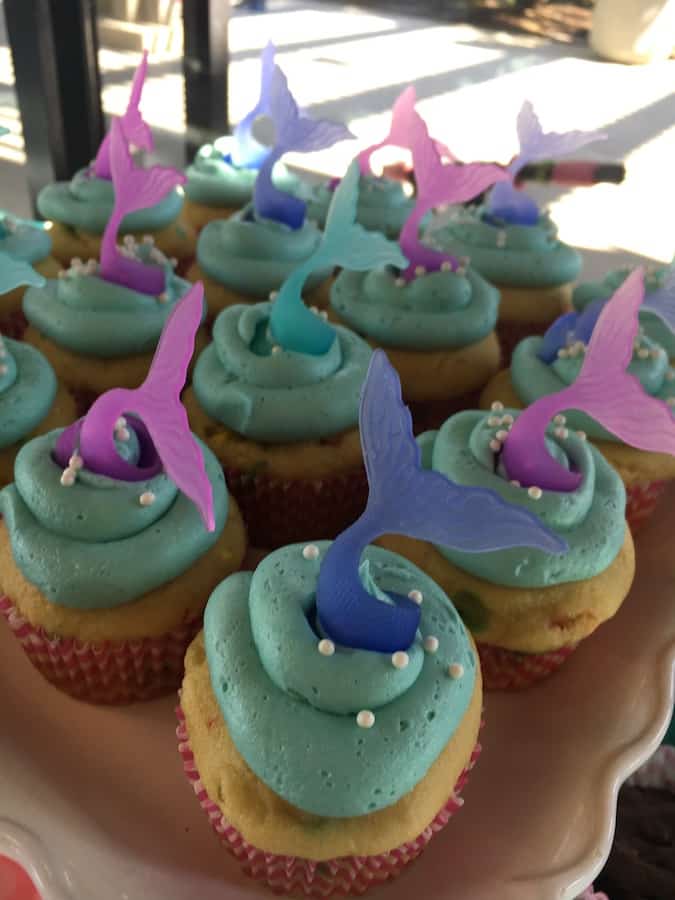 gluten-free mermaid party cupcakes with gluten-free funfetti cupcakes, gluten-free aqua frosting, white pearl sprinkles and blue and aqua mermaid tail rings for cupcake toppers