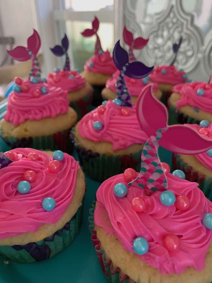 gluten-free mermaid party cupcakes with gluten-free funfetti cupcakes, gluten-free bright pink frosting, pink and aqua pearl sprinkles and pink, purple and aqua mermaid tail cupcake toppers