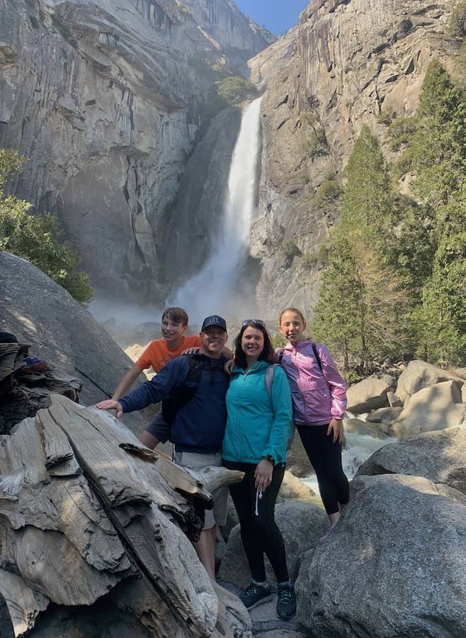 CJ, Dave, Heather & Miss E standing on rocks in front of Yosemite Falls