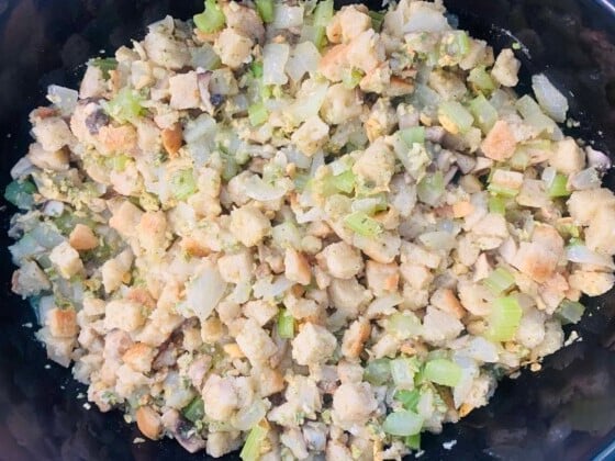 Dry breadcrumb mix tossed with cooked vegetables and seasonings, in a crockpot.