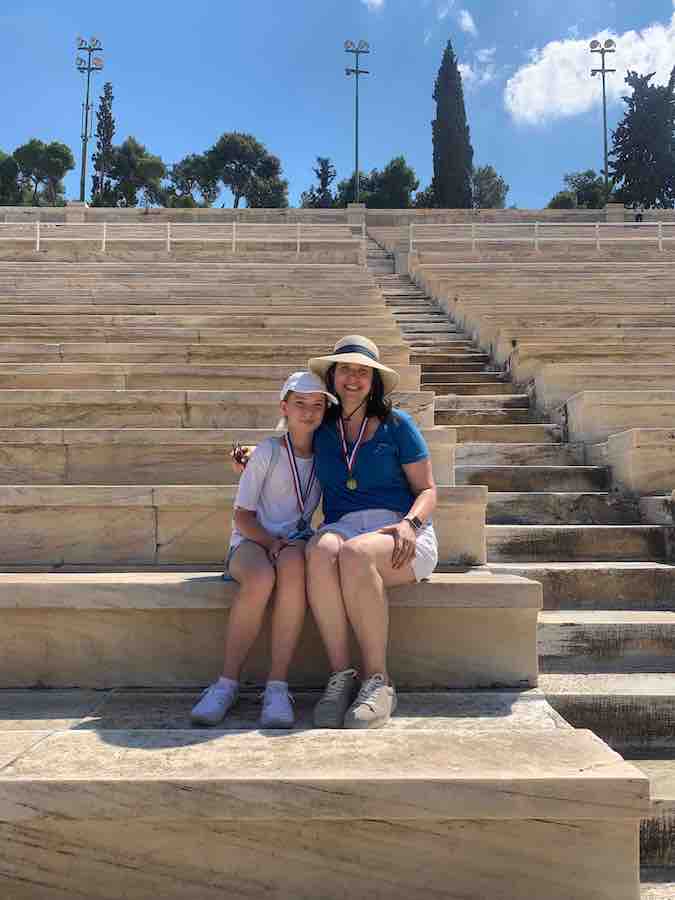 Miss E and Heather sitting on the bleachers of the Panathenaic Stadium