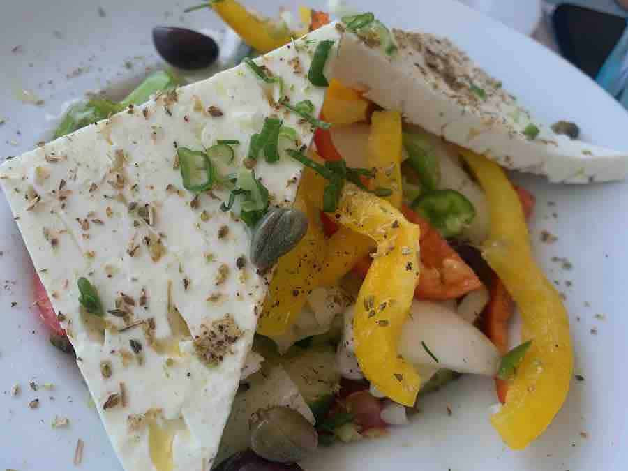 greek salad with barley rusk all over it