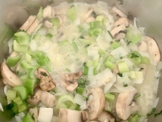 veggies sautéing in butter, onions are turning translucent