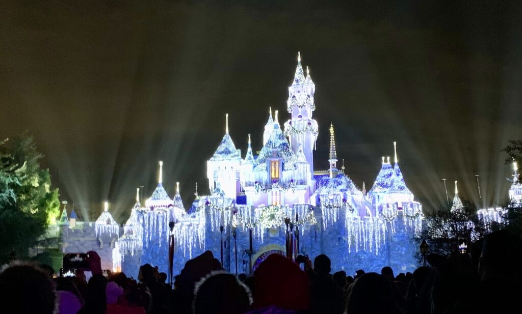 Sleeping Beauty Castle lit up with twinkling white lines for "Wintertime Enchantment"