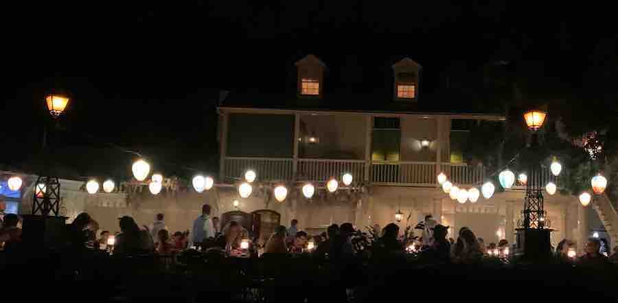 view of Blue Bayou restaurant, silhouettes of diners, strings of lights
