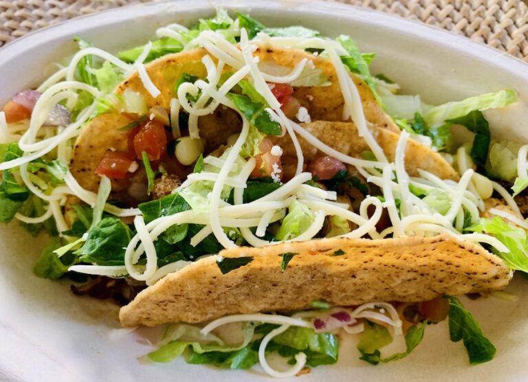 two Chipotle gluten-free crispy tacos chicken, lettuce, cheese and salsa