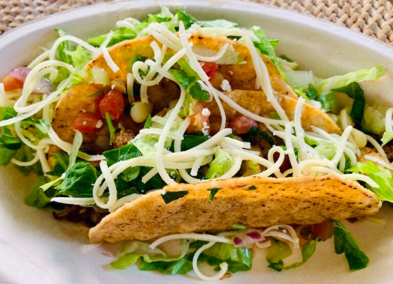 two Chipotle gluten-free crispy tacos chicken, lettuce, cheese and salsa