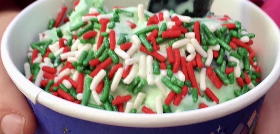 gluten-free mint ice cream in a cup with red, white & green Christmas sprinkles