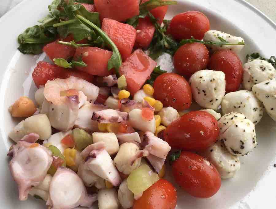 a variety of gluten-free salads: seafood, caprese, and watermelon salads