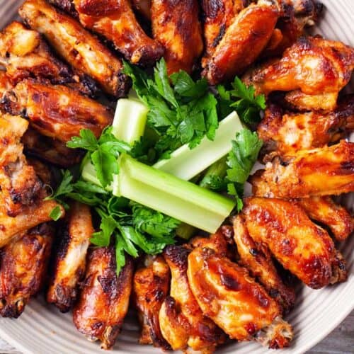 platter of chicken wings with celery and parsley in the center