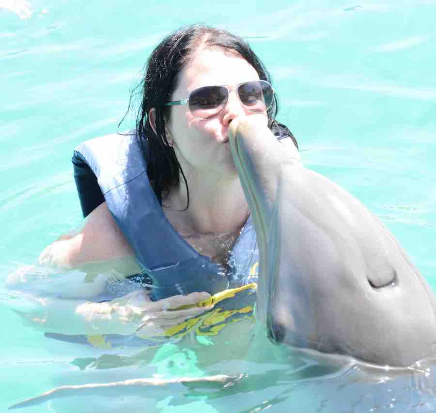 Heather kissing a dolphin