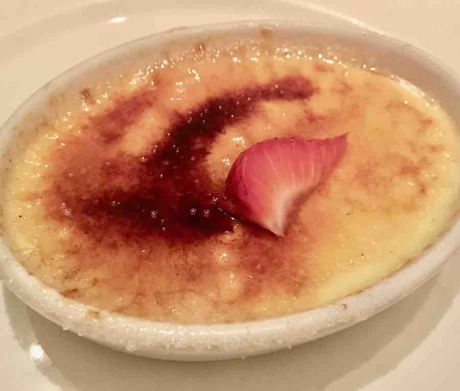gluten-free creme brûlée with a strawberry slice on top
