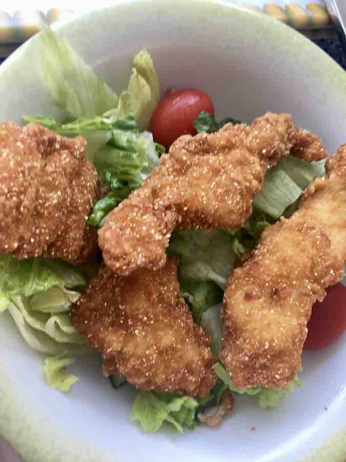 gluten-free chicken strips on a salad