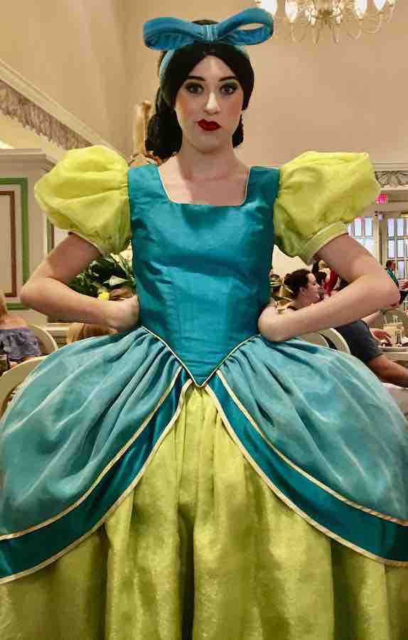 Drizella with a crooked-scowling look on her face and hands on her hips