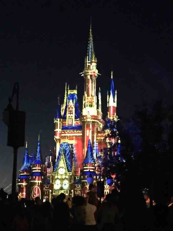 Disney World castle at night with projections