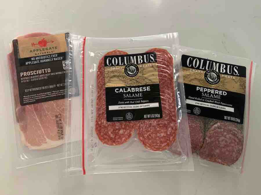 packages of prosciutto, salami and peppered salami