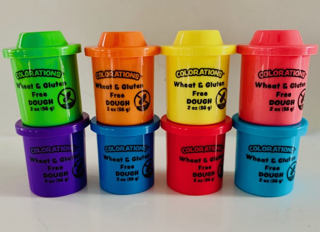 8 multi colored containers of gluten-free play-dough
