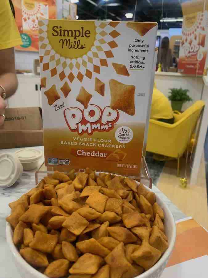 package of gluten-free Simple Mills Pop Mmms (in front of bowl of Pop Mmms)... they are puffed crackers, like goldfish, but are diamond shaped