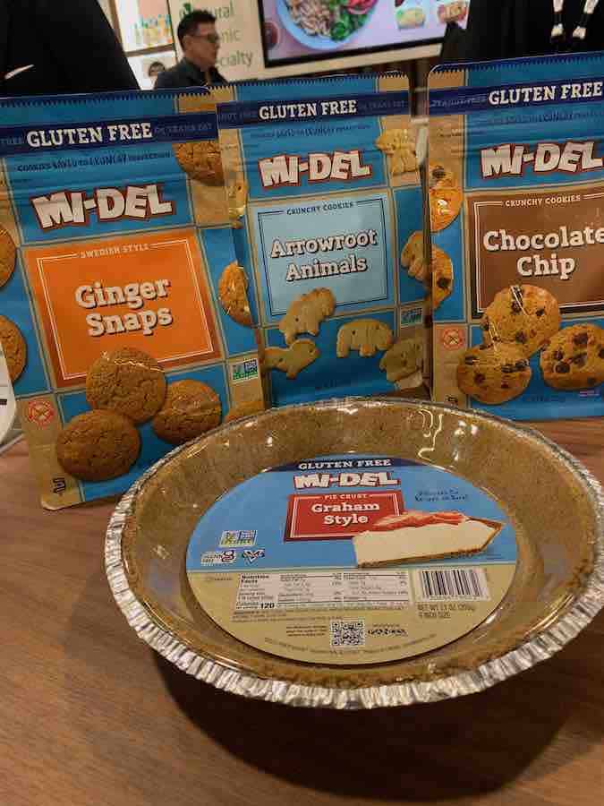 gluten-free cookies in the background (ginger snaps, animal crackers, chocolate chip cookies), gluten-free graham-style crust in the front