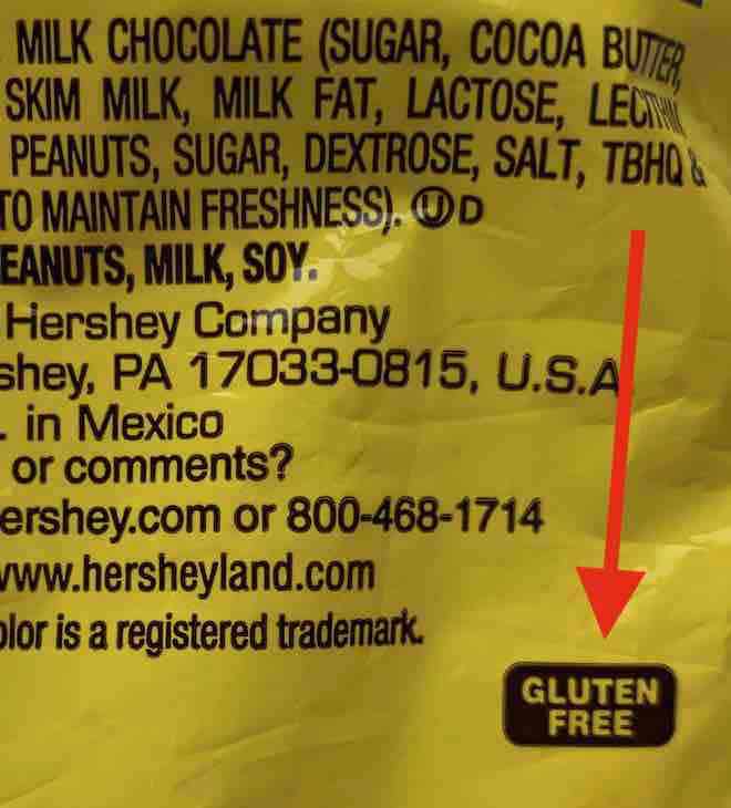 a package late for the Hershey Company showing it's gluten-free label... a red arrow points to the words gluten-free in a brown rectangle