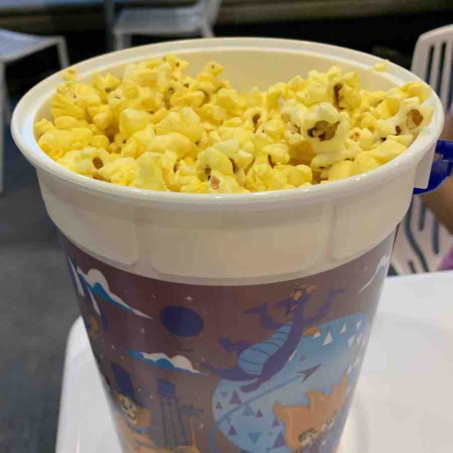 a bucket of popcorn on a table