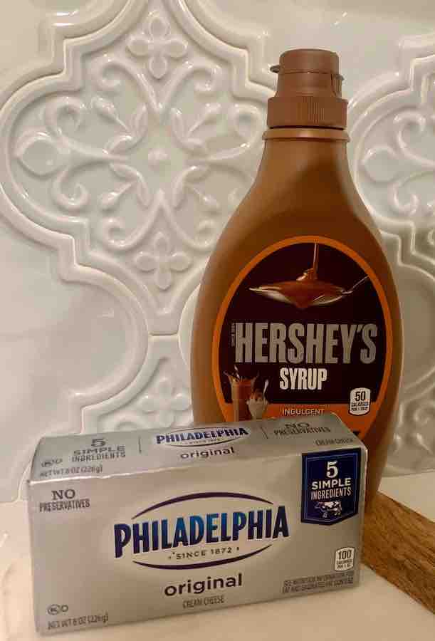a box of Philadelphia Cream Cheese and Hershey's Caramel Syrup