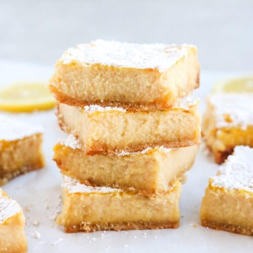stack of four gluten-free lemon bars, more in the background on the counter