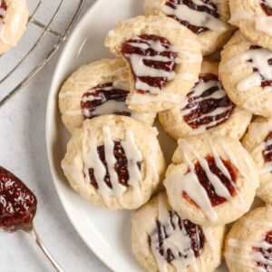 a pile of Gluten-free Raspberry Jam Thumbprint Cookies on a white plate