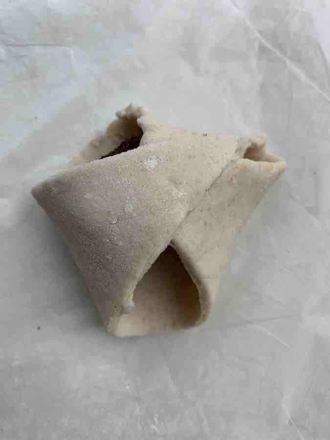 a gluten-free pizza dough triangle with all three ends folded in... it looks a bit like a diaper