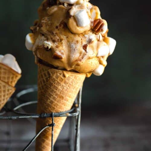 Homemade Sweet Potato Ice Cream with nuts and marshmallows, in a cone, resting in a rack