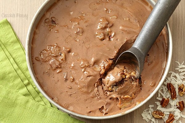 a scooper dipping into a tub of German Chocolate Cake Ice Cream