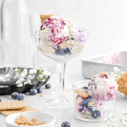 Blueberry Cheesecake Ice Cream in a tall glass and also in a short glass bowl