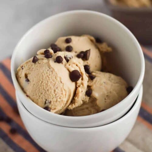 two bowls stacked with scoops of Coconut Espresso Ice Cream in the top bowl