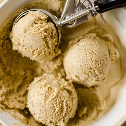 3 scoops of Homemade Coffee Ice Cream, and a scooper dipping into a tub of Homemade Coffee Ice Cream