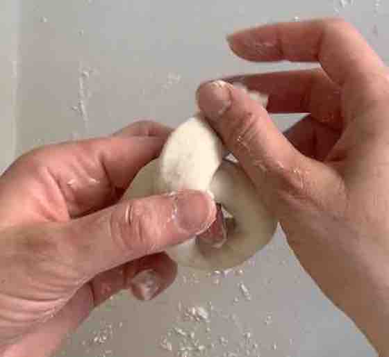 hands twisting ends of dough-rope