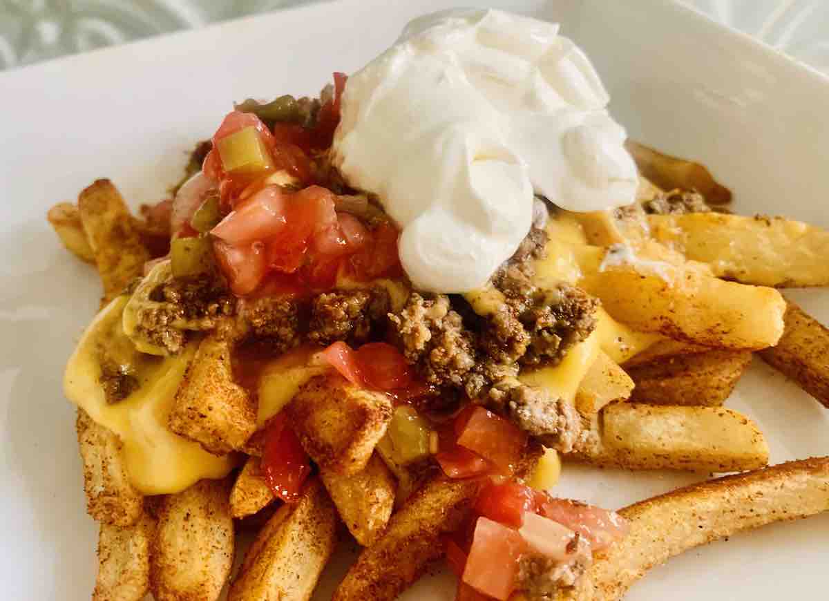 nacho fries topped with ground beef, salsa, and sour cream