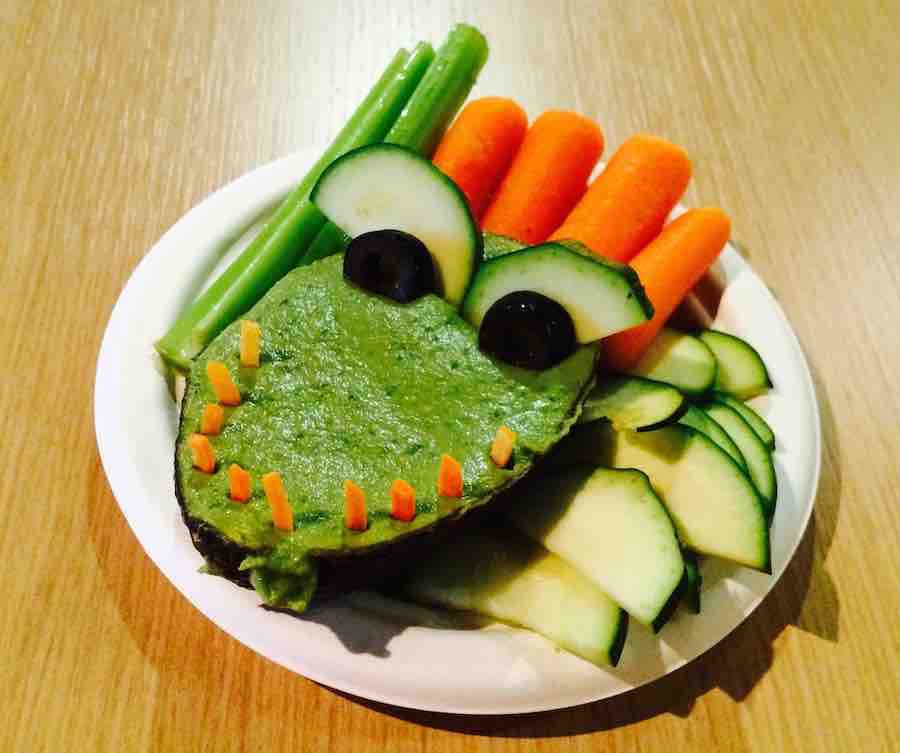 guacamole in half an avocado made to look like a crocodile... avocado in the.. shredded carrot for teeth, zucchini and olives for eyes... beans, carrots and zucchini for dipping
