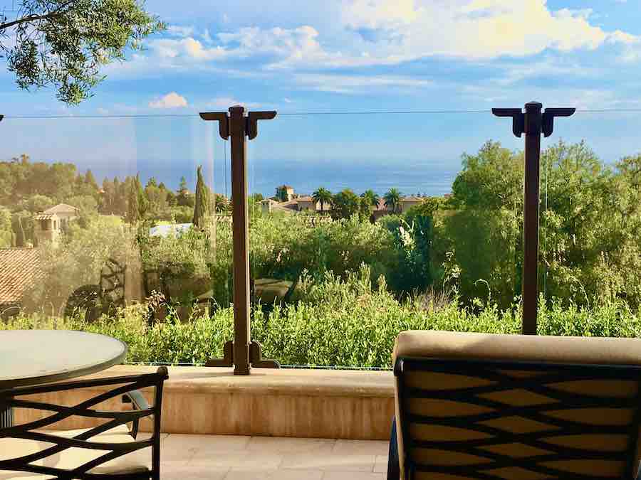 view of the grounds and beach from a patio at Pelican Hill Resort