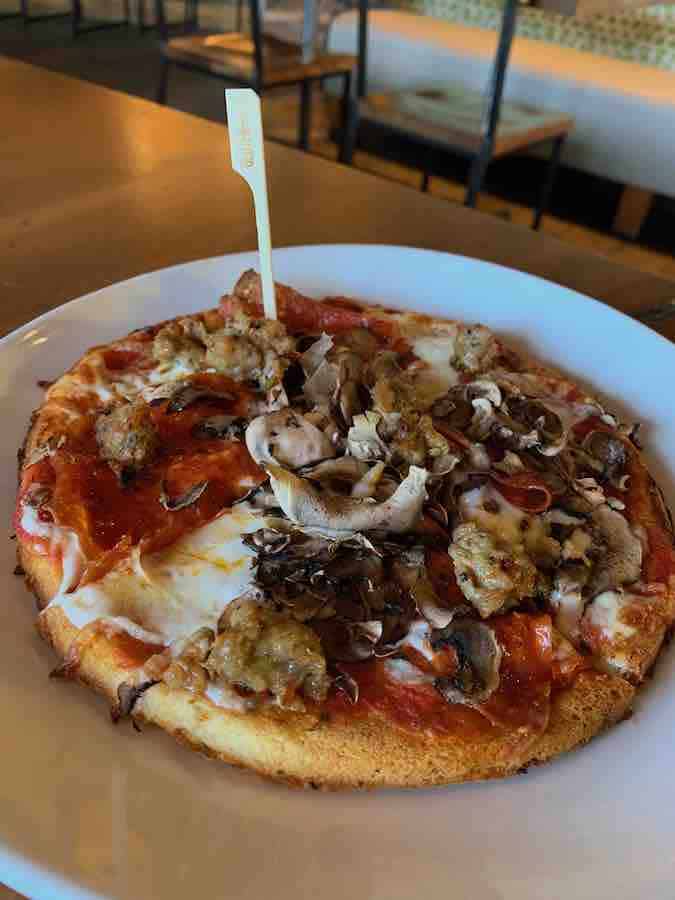 California Pizza Kitchen gluten-free pizza mushroom, pepperoni, sausage pizza with an allergy pick