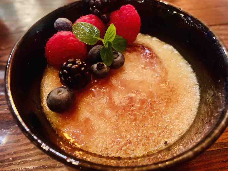 creme brûlée with mixed berries on top