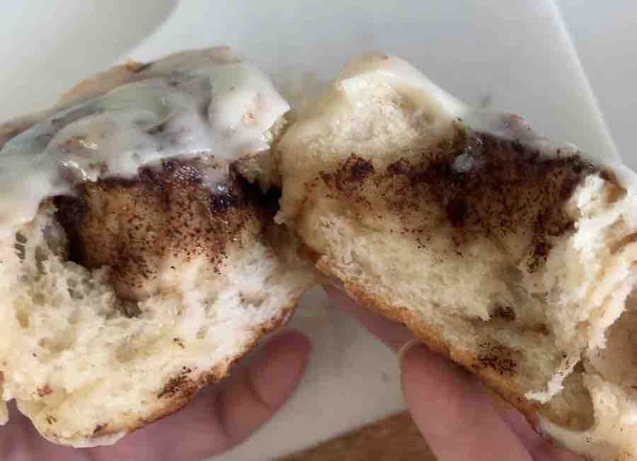 a gluten-free cinnamon roll torn open, showing the fluffy, airy texture